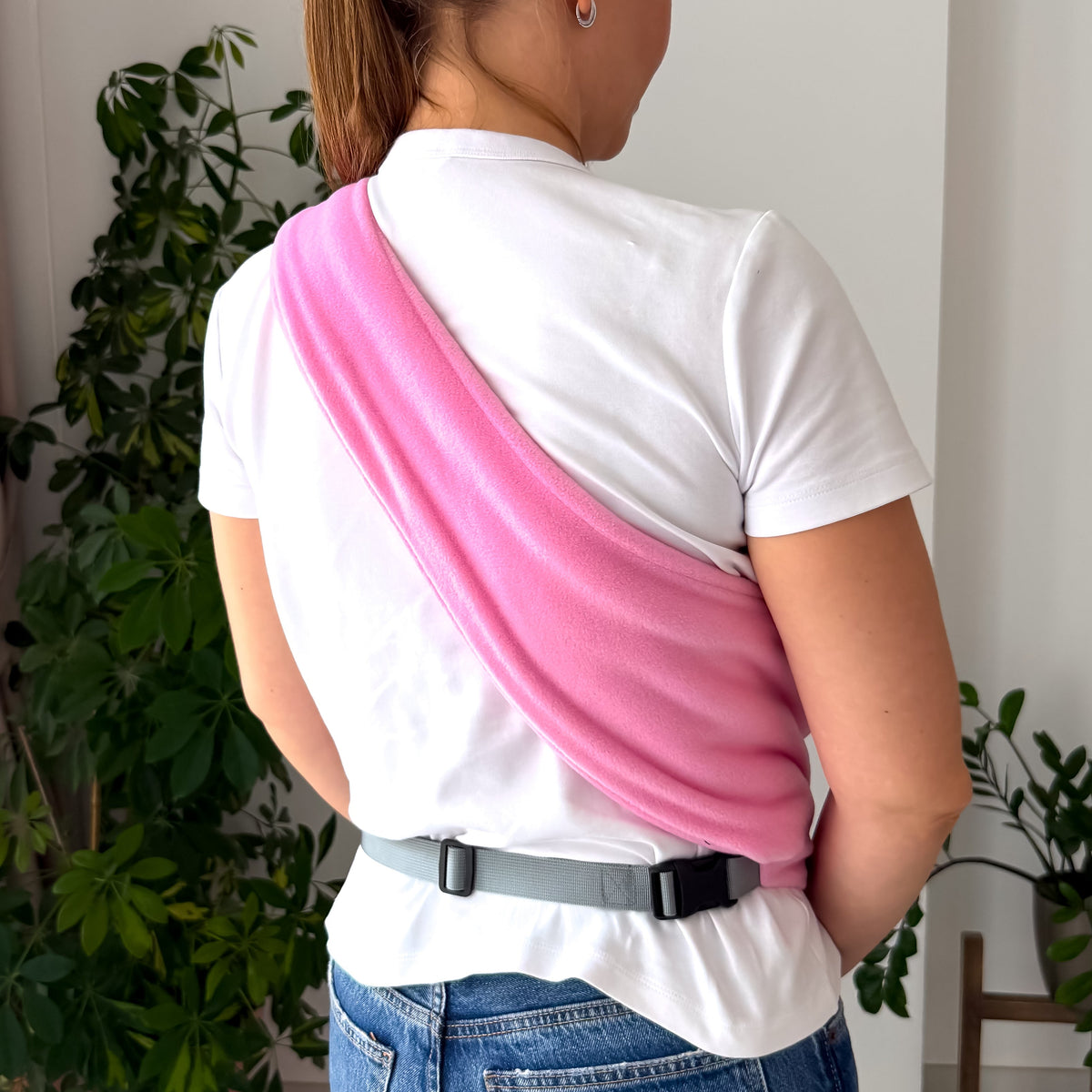 Small dog carried in a pink Fleece Security Dog Sling by Kokopaws