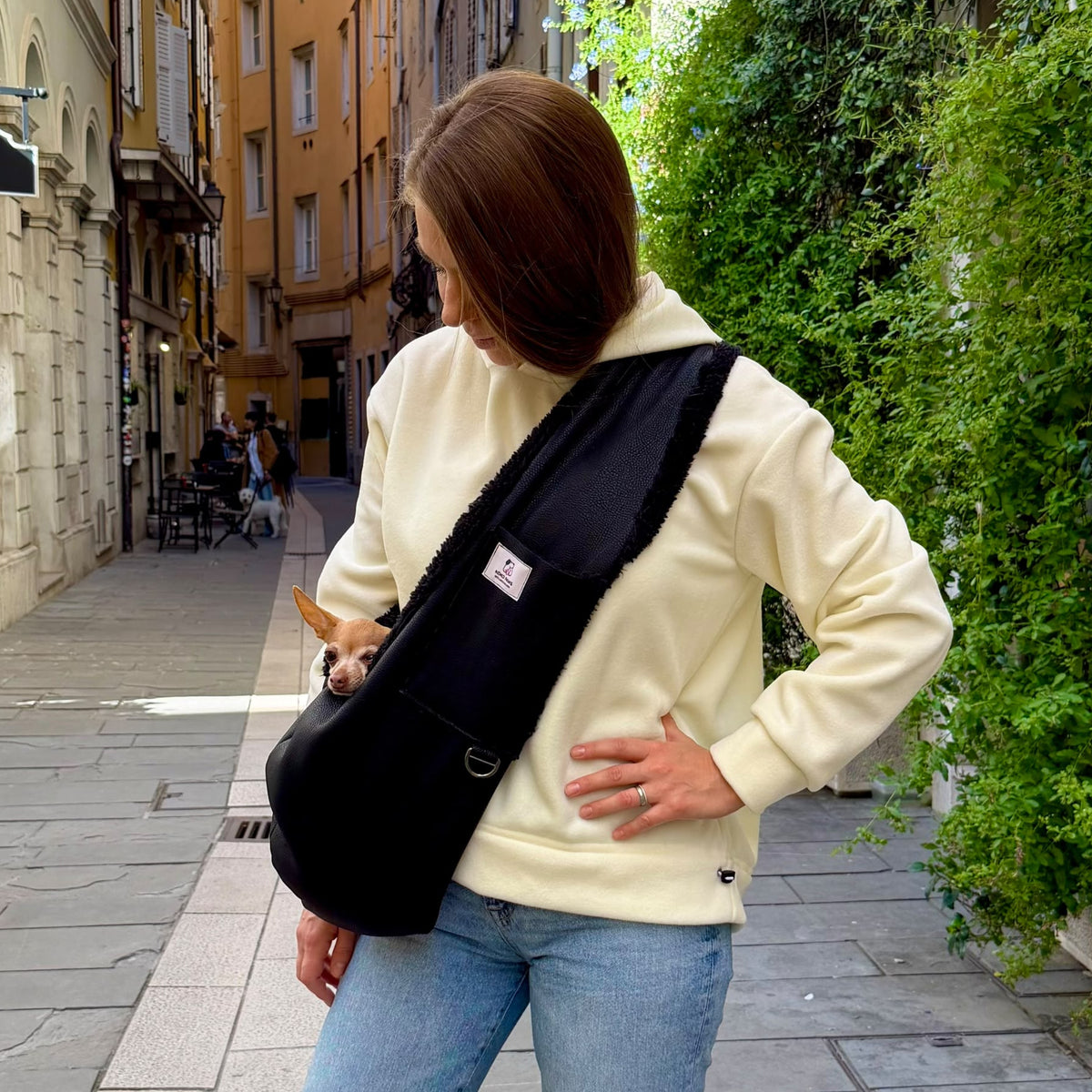 Black faux leather dog sling carrier for small dogs with plush faux shearling lining