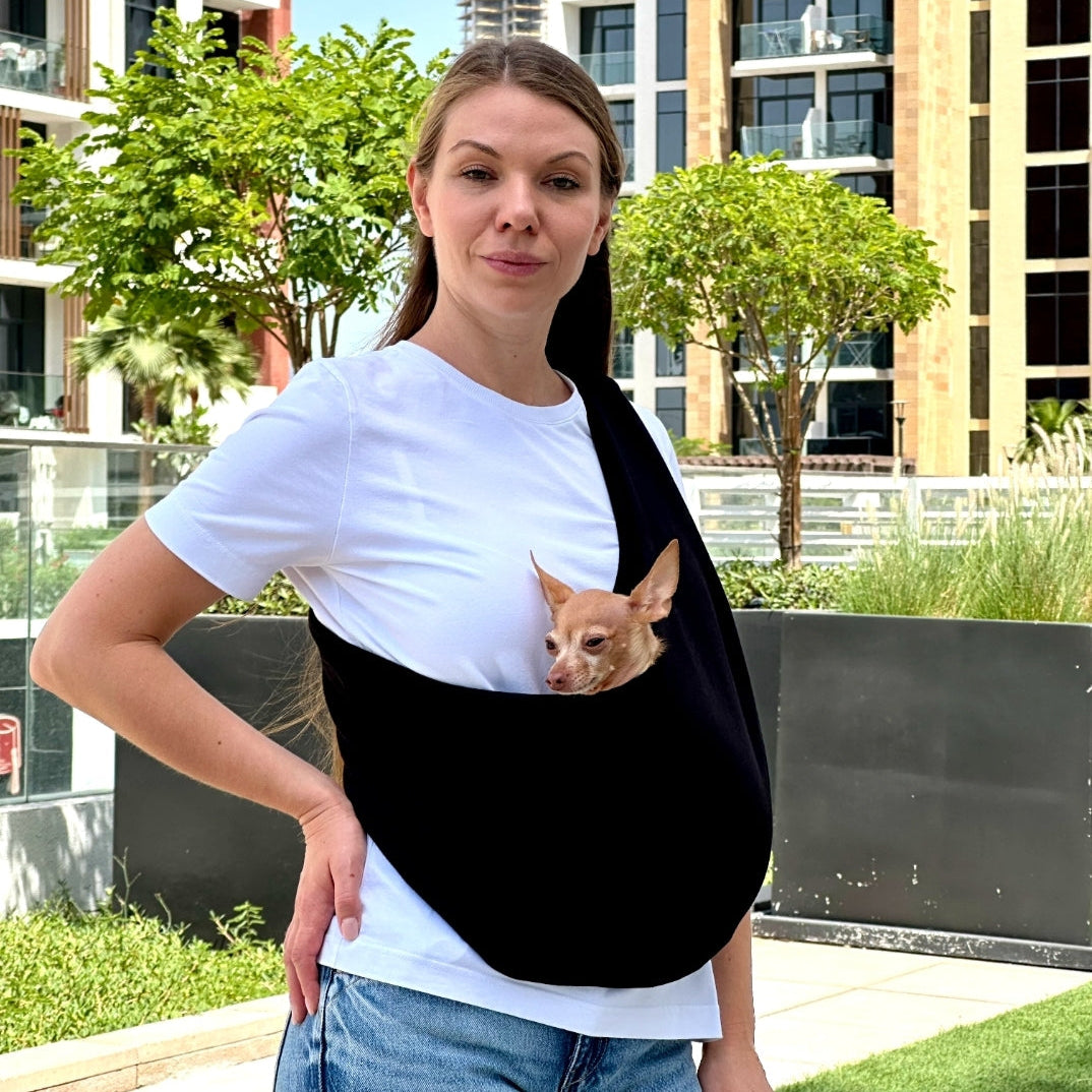 Small dog in black cotton sling carrier – lightweight pet bag for summer